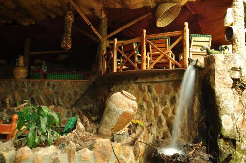 a stream of water coming out of a stone wall at Naiberi River Campsite & Resort in Eldoret
