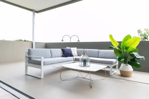 a living room with a couch and a table at 124 Modern 2Bed (21sq) in heart of Sorrento in Sorrento