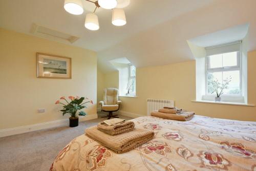 a bedroom with a large bed with pillows on it at The Lodge Elsdon in Elsdon