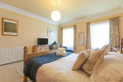 a bedroom with a large bed and a television at The Burgage House in Warkworth