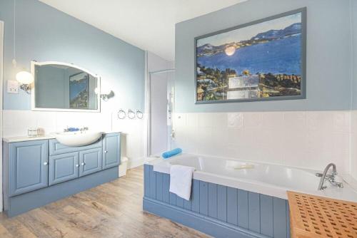 a bathroom with a large tub and a sink at The Burgage House in Warkworth