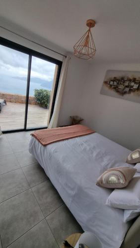 a bedroom with a bed with a view of the desert at Résidence Le Bella Vista in Piana