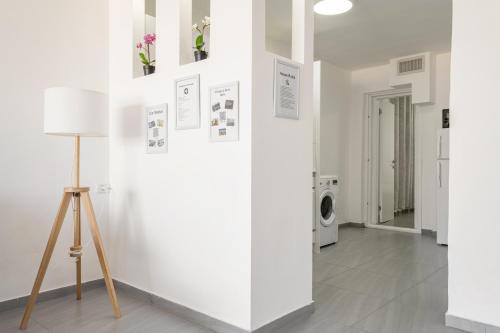 a room with a white wall with a washing machine at Abbas BayView Apartment in Haifa