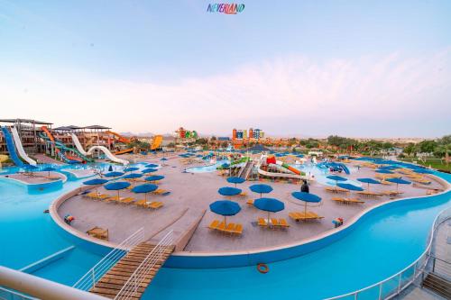 a water park with a water slide and chairs and umbrellas at Neverland City Hurghada - Pickalbatros in Hurghada