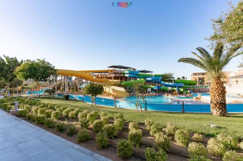 a resort with a water park with a slide at Neverland City Hurghada - Pickalbatros in Hurghada