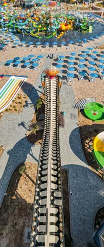 a view of a building on a beach with umbrellas at Neverland City Hurghada - Pickalbatros in Hurghada