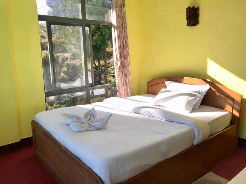 Una cama o camas en una habitación de Hotel New Dragon