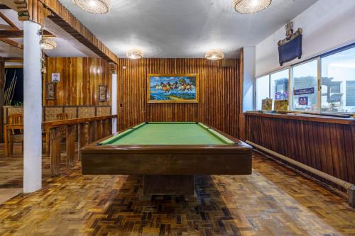 a billiard room with a pool table and a bar at Charisma Beach Resort in Siquijor