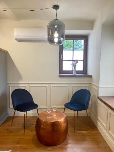 a room with two chairs and a table and a window at Segesdy Villa in Balatonalmádi