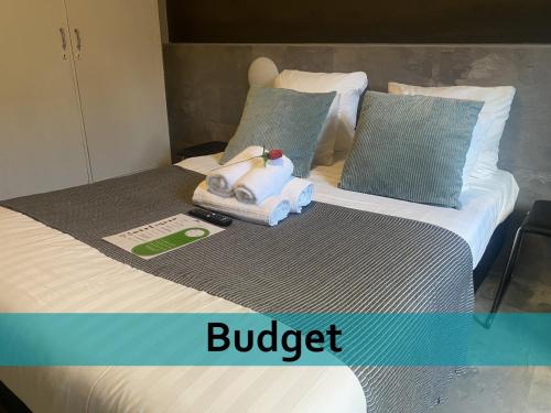 a bed with a bunch of towels on it at Grand Hotel Central in Rotterdam