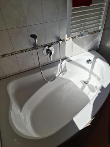 a white bath tub with a faucet in a bathroom at Ferienwohnung HOAMAT Schmalzreich Andrea in Lam
