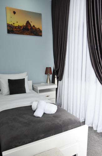 a bedroom with a bed with two white towels on it at Hotel PALACE in Velika Kladuša