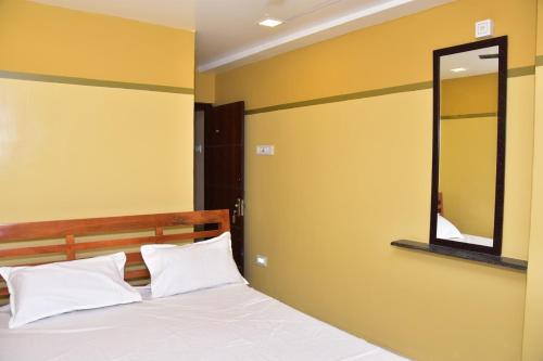 A bed or beds in a room at CHANDRA ROYAL RESIDENCY