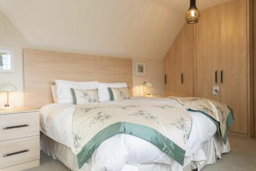 a bedroom with a large bed with a wooden headboard at Keeper's View in Bamburgh