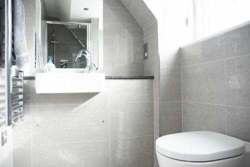 a bathroom with a white toilet and a sink at Keeper's View in Bamburgh