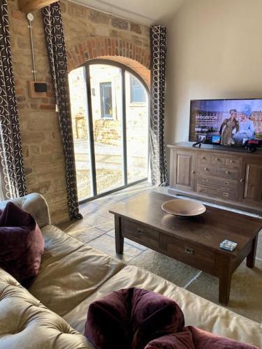a living room with a couch and a coffee table at Contemporary Luxury Barn Conversion in County Durham in Durham