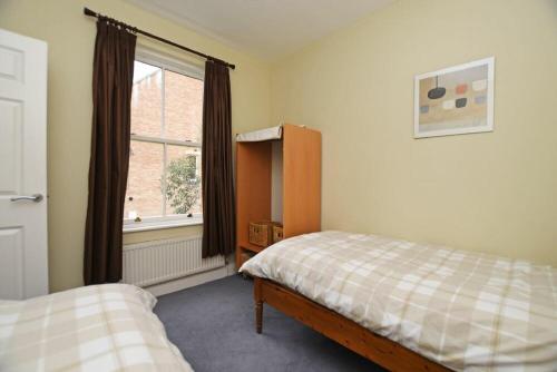 a bedroom with a bed and a window at Churchside in Alnwick
