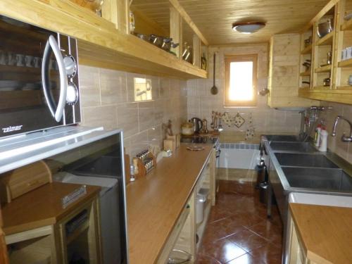 a kitchen with a sink and a counter top at Horáreň pod Dobákom in Lazisko