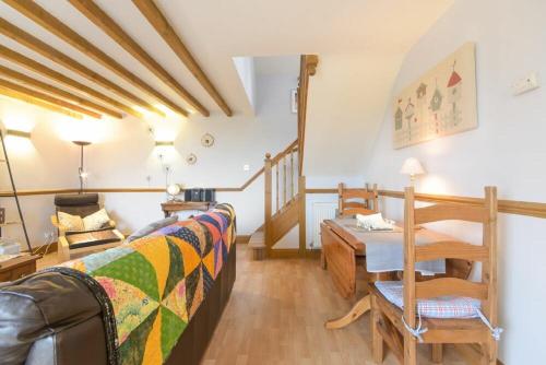 a living room with a bed and a table at Mossyford Cottage in Alnwick