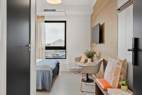 a hotel room with a bed and a window at Aiden by Best Western Herning in Herning