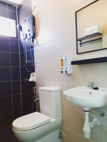 a bathroom with a toilet and a sink at KLIA Nilai Sepang EHSAN RESIDENCE 8 PAX Air-Con Homestay in Sepang