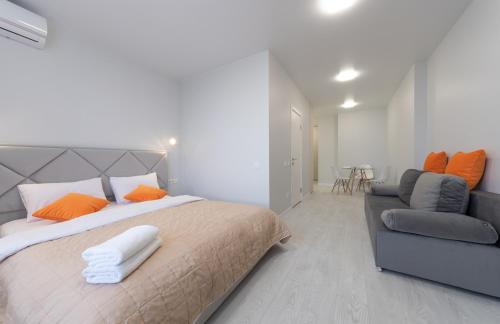 a bedroom with a large bed and a couch at Люкс на Бориспільській ЖК Олімпік Парк, генератор на будинку in Kyiv