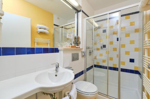 a bathroom with a sink and a toilet and a shower at Mare Mare Suites in Mali Lošinj