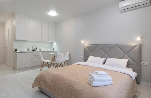 a bedroom with a large bed with towels on it at Люкс на Бориспільській ЖК Олімпік Парк, генератор на будинку in Kyiv