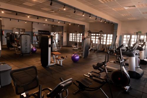 a gym with several treadmills and exercise bikes at Assiut Cement Hotel in Asyut