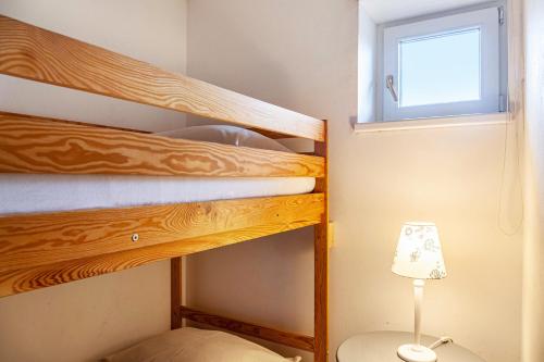 two bunk beds in a small room with a lamp at Haus Excelsior Top 2 in Seefeld in Tirol