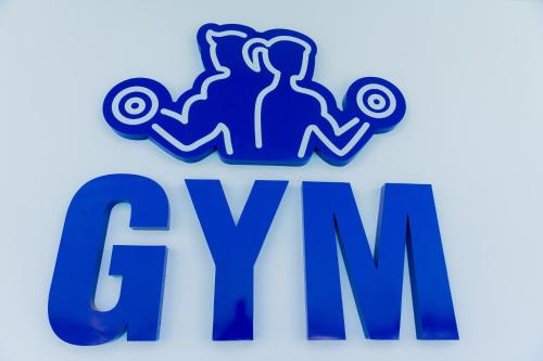 a blue mgm logo on a white background at Assiut Cement Hotel in Asyut