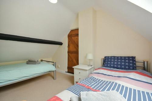 1 dormitorio con 2 camas en un ático en Old Stable Cottage, en Alnmouth