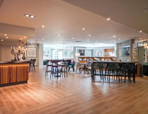 a dining room and living room with tables and chairs at Eastwood Hall in Eastwood