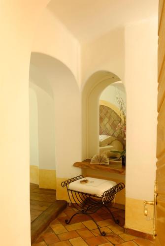 a living room with a table and a mirror at Hôtel Le Belvédère in Porto-Vecchio