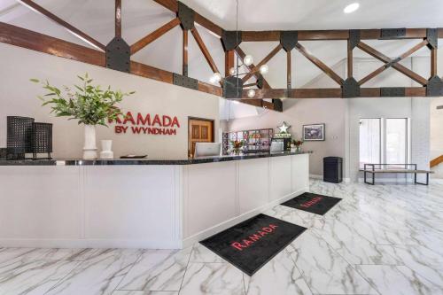 a bar in a large room with wooden beams at Ramada by Wyndham Richfield UT I-70 in Richfield