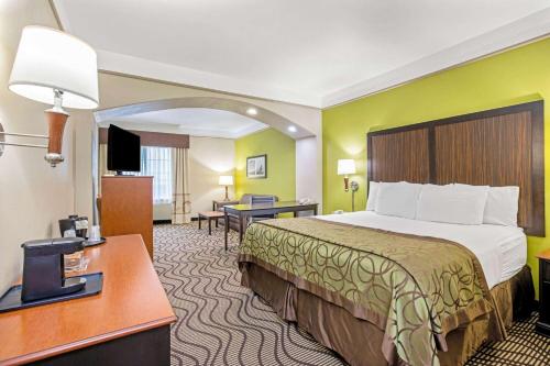 a hotel room with a bed and a desk at La Quinta by Wyndham Corpus Christi Airport in Corpus Christi