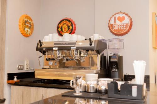 a kitchen with a coffee machine on a counter at Assiut Cement Hotel in Asyut