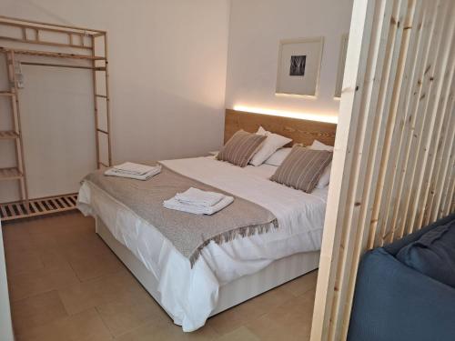 a bedroom with a large bed with towels on it at Precioso loft al lado Parc Vallparadís by Lofties in Terrassa