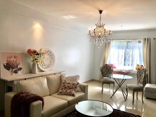 a living room with a couch and a table at Sunny Rooms Mascot in Sydney