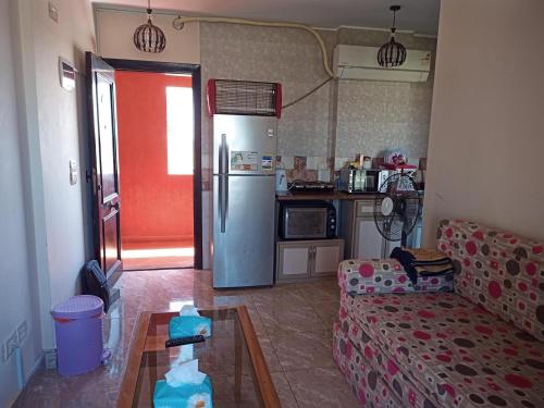 a living room with a couch and a refrigerator at Golf Porto Marina in El Alamein
