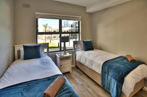 En eller flere senge i et værelse på Nivica Lifestyle Living Nr 19, Langebaan
