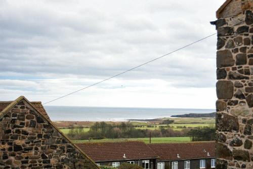 a view of the ocean from a castle at The Snug in Embleton