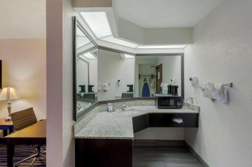 a bathroom with a sink and a large mirror at Comfort Inn & Suites in Brentwood