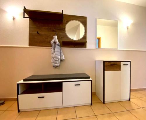 a bathroom with a counter and a mirror on the wall at Haus am Kölpinsee App 4 4 in Kölpinsee