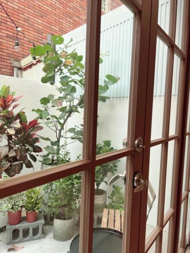 an open door to a balcony with potted plants at HoME-Easyhouse-III in Tainan