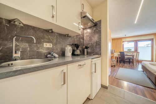 a kitchen with a sink and a counter top at Appartementhaus im Winkel in Sölden