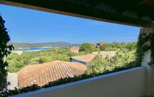 a view from a window of roofs and trees at Apartments in residence with swimming pool in Porto Rotondo in Porto Rotondo