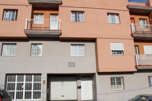 a large apartment building with two white garage doors at Dreamy in San Isidro