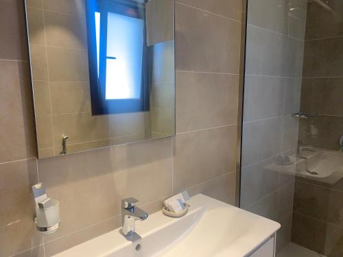 a bathroom with a sink and a mirror at Townhouse Paolo in Salalah