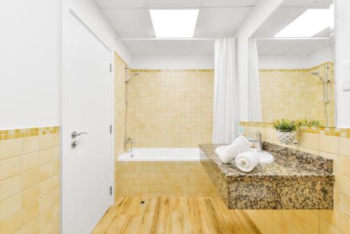 a bathroom with a tub and a sink at Luxury JBR · Full Sea View · Free 5* Beach Resorts Access in Dubai